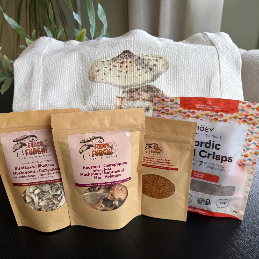 Funky Fungi gourmet mushroom products with a tote bag featuring a mushroom design on a dark surface.