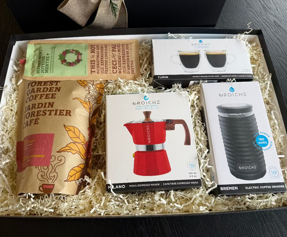 Gift set with coffee products including a coffee maker, grinder, and coffee bags.