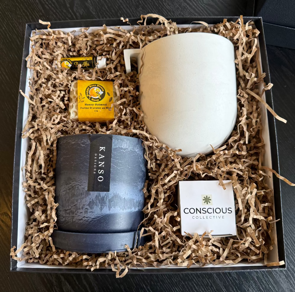 Gift set with planters, soap, lip balm and a tree in a box labeled 'Conscious Collective'.