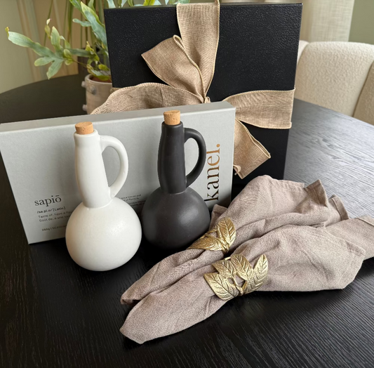 Decorative setting with ceramic vases, napkin, and decorative box on a table.