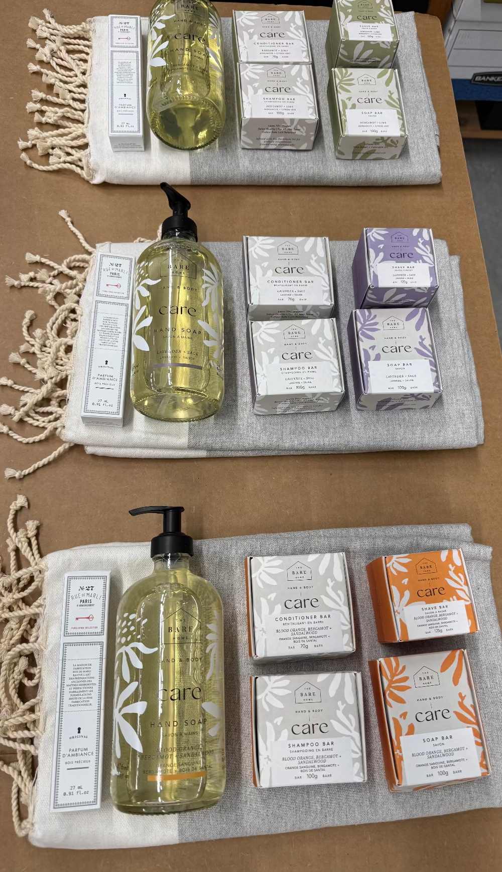 Assorted skincare products including bottles and boxes on a textured surface.