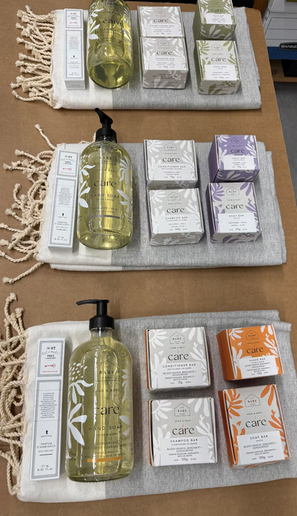 Assorted skincare products including bottles and boxes on a textured surface.