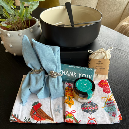 Table setting with a napkin, bowl, and decorative items on a dark surface.